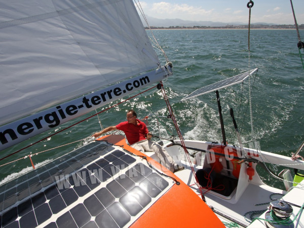 Jacques Riguidel sur son voilier équipé de panneaux solaires flexibles pour alimenter certains appareils.