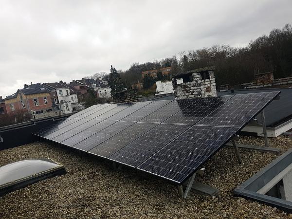 Flat roof of a house with photovoltaic panels on a flat roof mounting structure