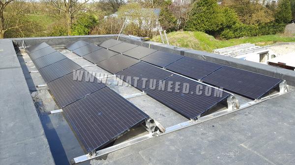 Flat roof of a house with photovoltaic panels on a flat roof mounting structure