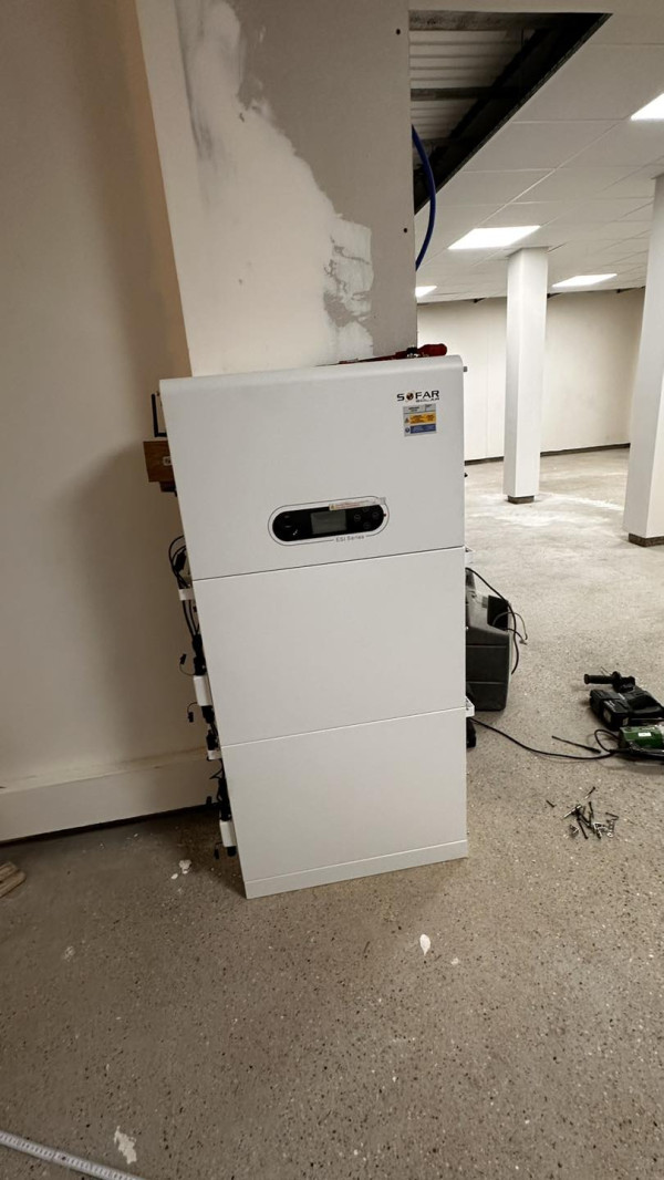 Inverter with surge protection box and lithium battery in a room of a house