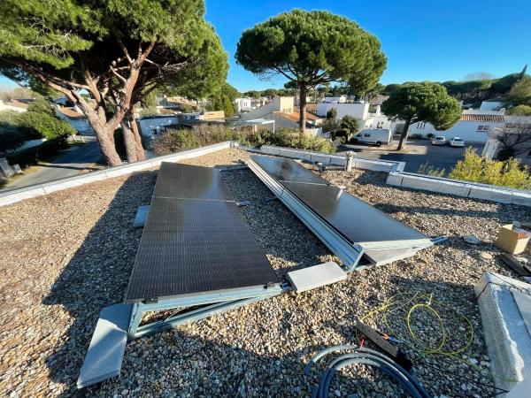 Flat roof of a house with photovoltaic panels on a flat roof mounting structure